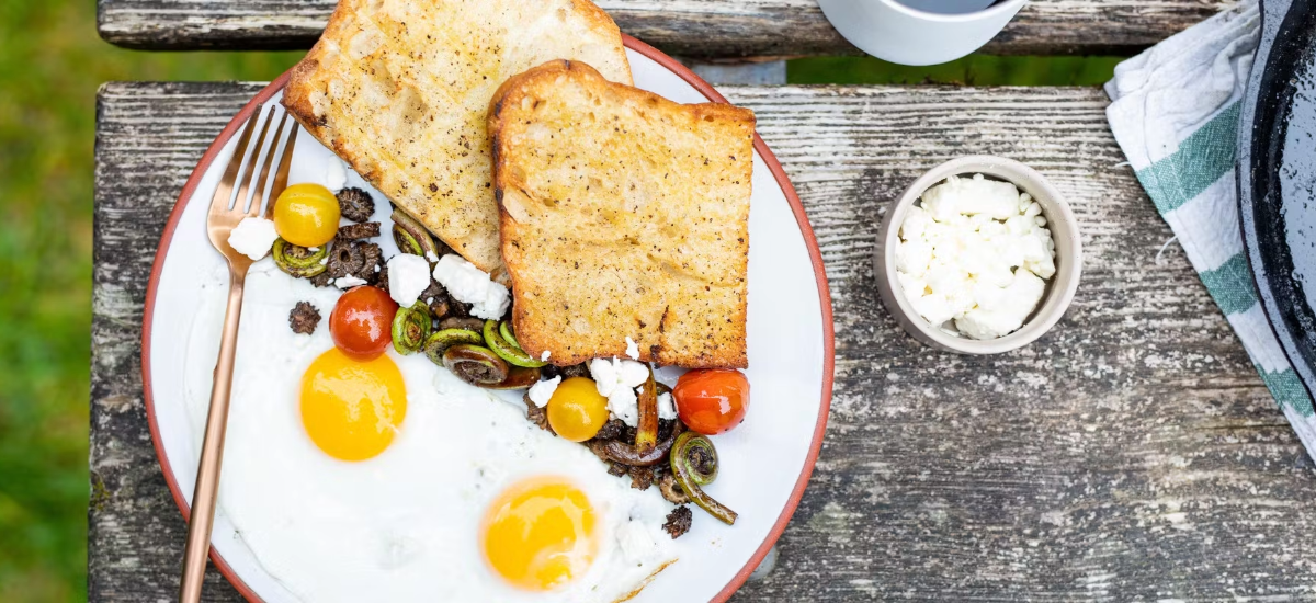 CAMPFIRE-SAUTÉED MUSHROOMS AND FIDDLEHEADS WITH SUNNY-SIDE EGGS